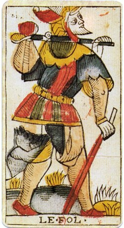 The Fool, from a Marseille tarot: a traveller walking on with his bundle on a staff and a beast at his heel.